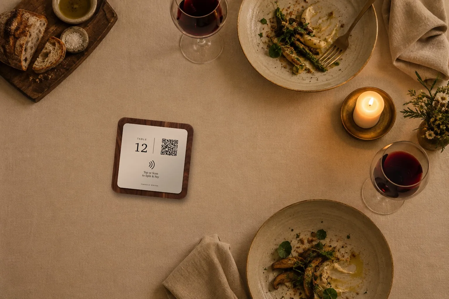 A RHYKA plaque on a candlelit restaurant table